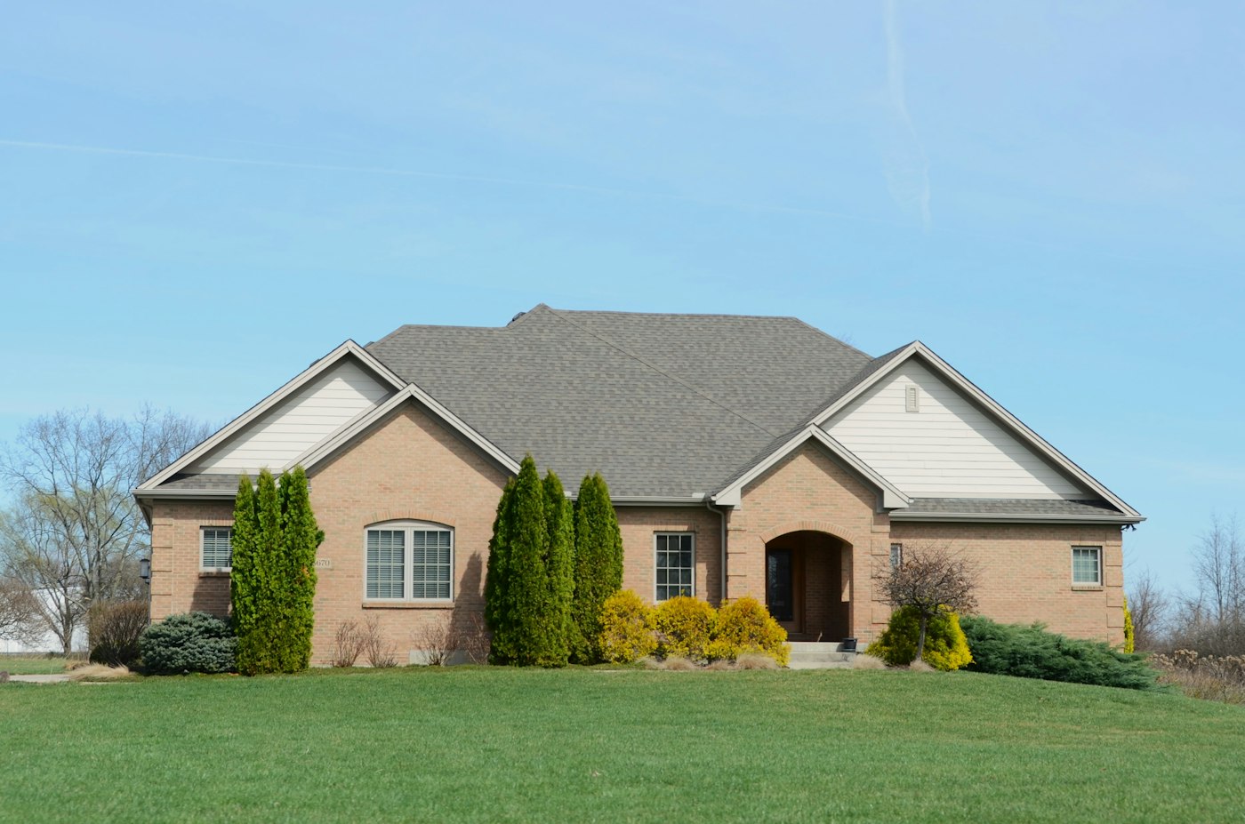 Healthy lawn and shrubs in front of a family home